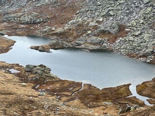 View of the alpine lake Laghi d'Orsirora in the autumn atmosphere in the mountainous area of the St. Gotthard Pass (Gotthardpass), Airolo - Canton of Ticino (Tessin), Switzerland (Schweiz)