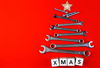 Christmas tree made of metal tools and inscription 