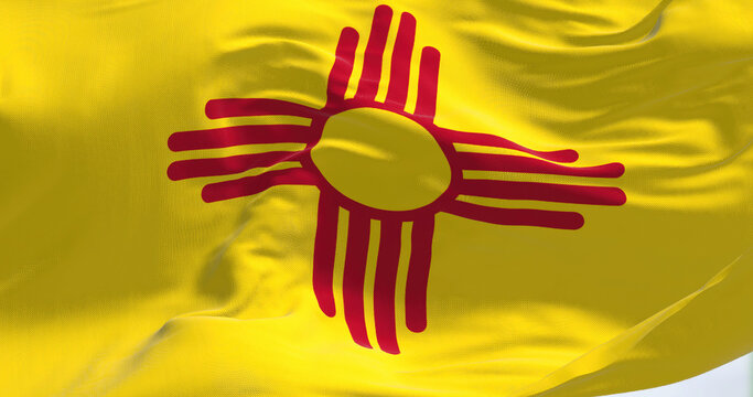 Flag of New Mexico state waving in the wind on a clear day