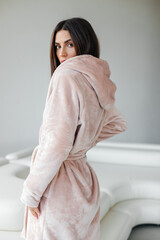 Young healthy serene woman girl relaxing in bathrobe and spa towel after having bath shower at...