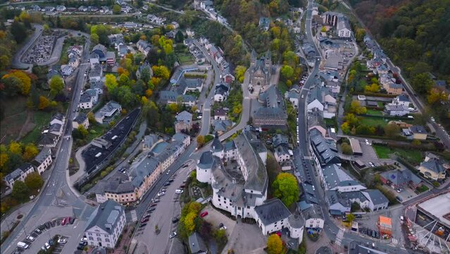 Aerial drone Shot of town CLervaux on the north of Luxembourg. Twilight evening scene with Castle and Cathedral