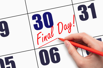 30th day of the month. Hand writing text FINAL DAY and drawing a line on calendar date.