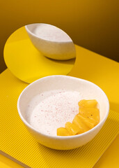 porridge with pineapple on a yellow background