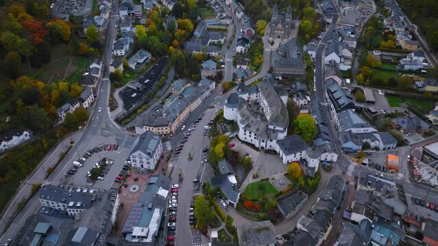 Aerial drone Shot of town CLervaux on the north of Luxembourg. Twilight evening scene with Castle and Cathedral