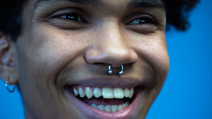 Close up view of cheerful african american man looking away isolated on blue