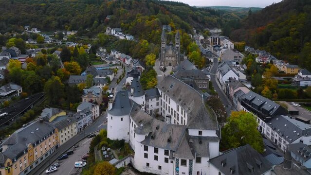 Aerial drone Shot of town CLervaux on the north of Luxembourg. Twilight evening scene with Castle and Cathedral
