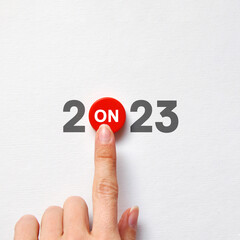 An unusual inscription 2023 with a start button. A symbol of the upcoming progressive new year
