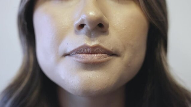 A close up shot of a hispanic female saying ok in multiple styles and speeds. Shot in 4k 60fps for high quality slow motion.