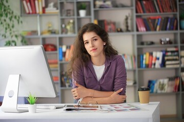 Fototapeta premium Beautiful business woman sitting in office and working on pc