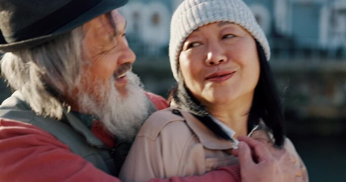 Love, hugging and senior asian couple in the city, enjoying travel vacation in Amsterdam. Affection, smile and elderly Chinese man and woman happy together, talking and embrace, holding each other