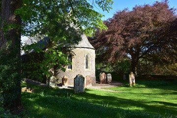 Fototapeta na wymiar Old Stone Church in a Cemetery in Ennerdale