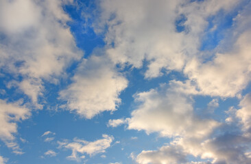 Summer evening sky in the picturesque clouds, lit by the rays of the setting sun.