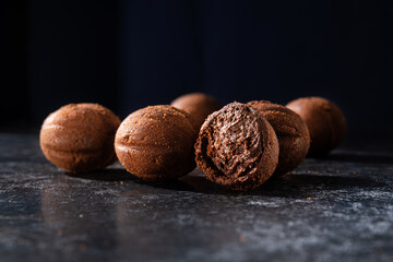 Tasty chocolate balls on a stone dark table.