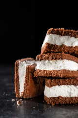 Tasty chocolate biscuit cake on a stone dark background