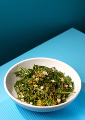 buckwheat porridge with broccoli on a blue background