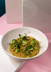 porridge with broccoli on a pink background