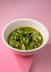 cream broccoli soup on a pink background