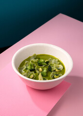 cream broccoli soup on a pink background