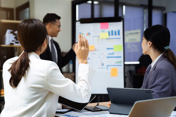 Group of Young Asian business team creative businesspeople coworker in office. Meeting Presentation for analysis graph company financial. People Work in Business Office.