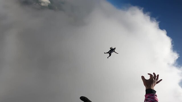 Skydiving point of view above the clouds