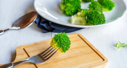 Close-up of  green fresh vegetable broccoli. Fresh green broccoli on wooden table.Broccoli vegetable is full of health .Vegetables for diet and healthy eating.Organic food.