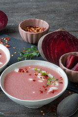red beetroot soup with chili flakes and thyme, homemade and served in bowls