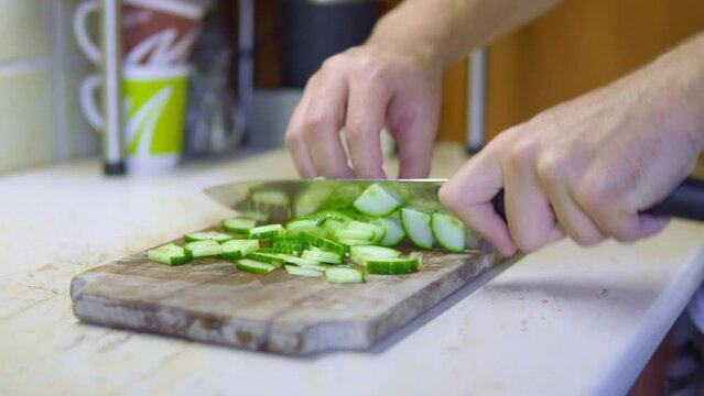 chopping cucumber for salad, chef fast hands