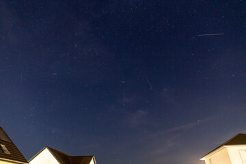 Starry sky over a housing settlement with meteorites (Perseids in August)