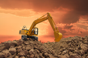 Crawler excavator   in the construction site  on orange sky  background.