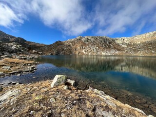 A crystal clear alpine lakes Laghi d'Orsirora during a beautiful autumn day in the mountainous area of the St. Gotthard Pass (Gotthardpass), Airolo - Canton of Ticino (Tessin), Switzerland (Schweiz)