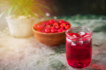 Glass of sour cherry juice with fresh red cherries, Cherry juice, on wood background, red drink, High vitamin C and antioxidant fruits.