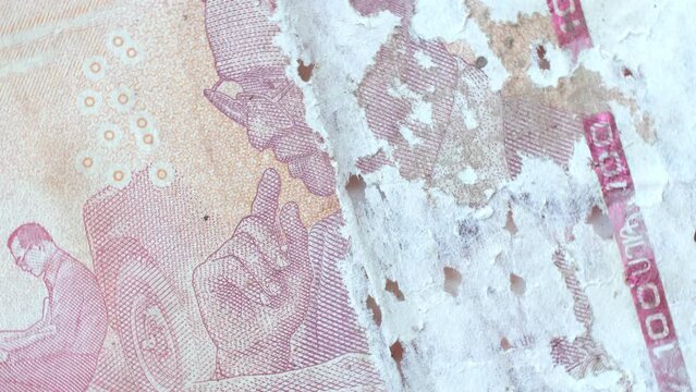 Footage 4K. Cash, Thai banknotes, damaged, torn, damaged, currency in circulation, baht is the official currency of Thailand.