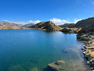 Fototapeta premium A crystal clear alpine lakes Laghi d'Orsirora during a beautiful autumn day in the mountainous area of the St. Gotthard Pass (Gotthardpass), Airolo - Canton of Ticino (Tessin), Switzerland (Schweiz)