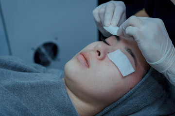 Young woman doing bio light red light therapy on her face Woman blindfolded and irradiated facial skin care, Bio light therapy in beauty clinic,  light for facial rejuvenation, Beauty concepts.
