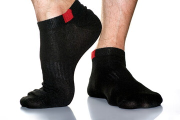 black men's socks with a red insert on the feet, legs in socks on a white background