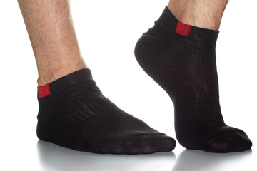 black men's socks with a red insert on the feet, legs in socks on a white background