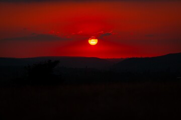 Red sunset. Dark mount background