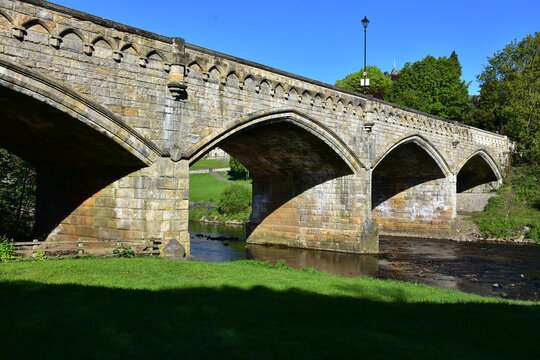 Attractive Arched Stone Bridge Over a Flowing River