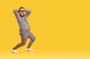 Crazy funny fat man with big belly in pajama suit with leopard print is dancing and fooling around....