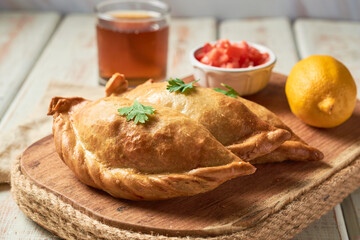 Traditional Argentinian baked empanadas on a wooden rustic table