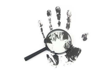 Magnifying lens and black hand print on white background. Investigation concept.