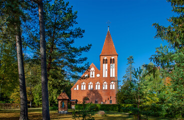 Fototapeta premium General view and architectural details of the Protestant temple, erected in 1905, now as the Catholic Church of Our Lady of Perpetual Help in the town of Spychowo in Masuria in Poland.