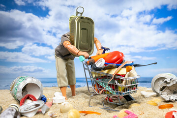 A male doll pushes a trolley full with trash on beach