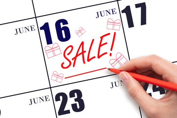 Hand writing text SALE and drawing gift boxes on calendar date June 16. Shopping Reminder