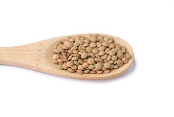 Raw lentils on a spoon isolated over white background