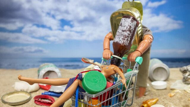 A male doll pushes a trolley full with trash on beach