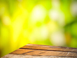 brown wooden table  green forest blur background