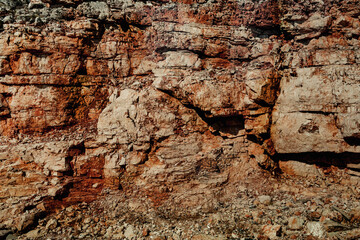 Grungy cragged bumpy pitted cavity stone facade, split layer gap.Ruined cracked shattered worn rough hiking canyon.Old ragged grunge steep marble cliff. Grand vintage crannied damaged impressive gorge