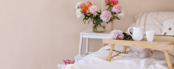 Banner bouquet of fresh flowers in a home light modern interior. Fresh flowers in the morning in the bedroom.
