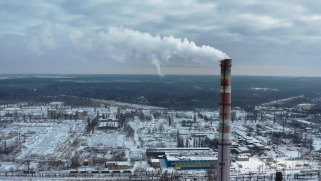 Air environment pollution concept. Smoke or hot steam from tube chimney of power chemical petrochemical oil and gas refinery plant complex. Industrial winter landscape. TPP. TPS. Flying towards